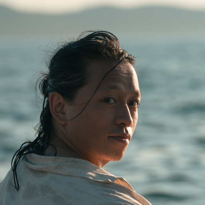 Side profile of Viet sitting by the water